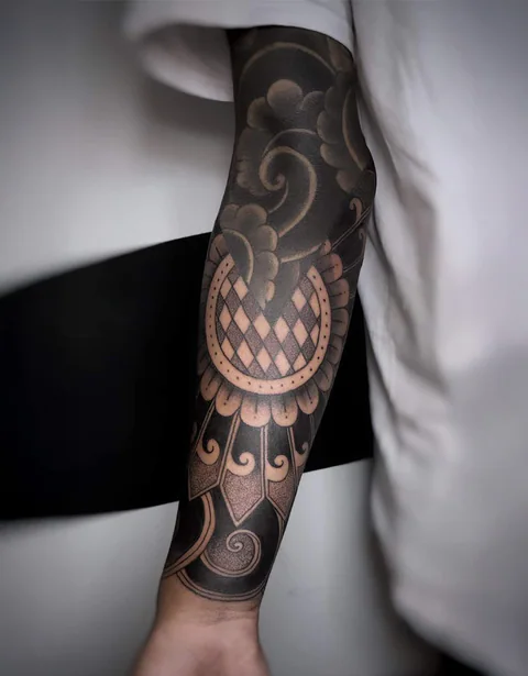 Ornamental blackwork sleeve tattoo