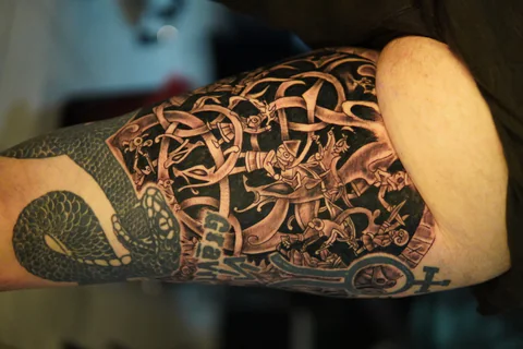 Knotwork sleeve tattoo with snake